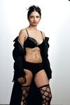 Beautiful Indian female sheds an overcoat to model in underwear and stockings
