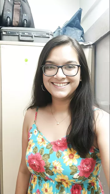 Smiling Indian girl in glasses goes nude for lover