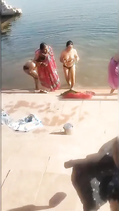 Shameless Desi bhabhi poses topless on the river bank in XXX video