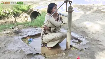 Young village school girl taking a bath in a sari and caught on camera