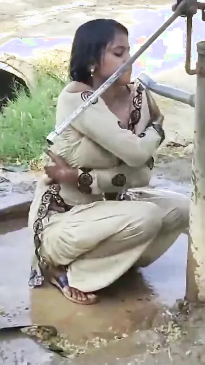 Young village school girl taking a bath in a sari and caught on camera