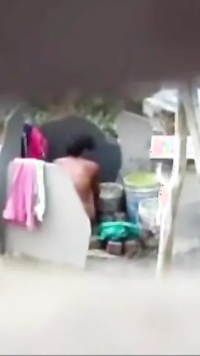 Neighbor on a hidden camera caught aunt taking a bath on the outdoor naked