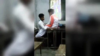 Young Lovers Kissing And Touching In Empty Classroom