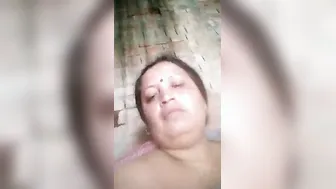 Older Indian widow winks whilst engulfing own large boobs