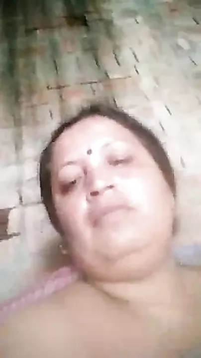 Older Indian widow winks whilst engulfing own large boobs