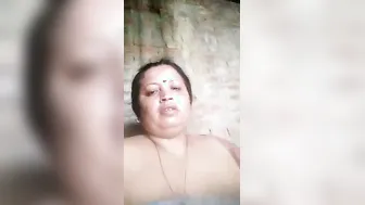Widow Teasing Camera Sucking Her Own Massive Boobs Winking Sexy