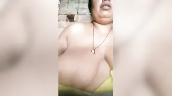 Widow Teasing Camera Sucking Her Own Massive Boobs Winking Sexy