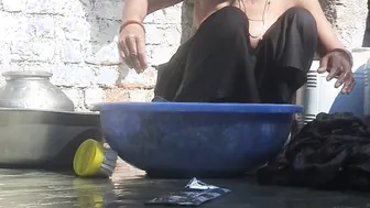 Indian Stepsister Washing Clothes In Open Courtyard Preparing For Bath