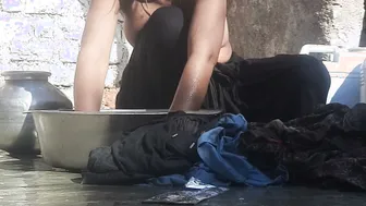 Indian Stepsister Washing Clothes In Open Courtyard Preparing For Bath